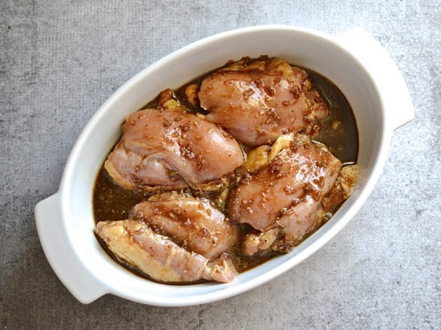 Marinated chicken thighs in casserole dish ready to bake