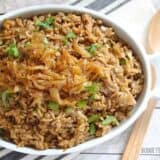 A close-up of mujaddara topped with caramelized onions.