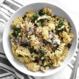 Parmesan & Pepper Kale Pasta is a quick and easy weeknight meal. Just a few ingredients transform boring pasta into a fancy meal. BudgetBytes.com