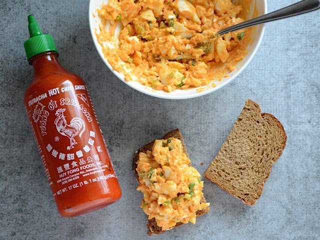 Egg salad mixture placed on half a piece of bread 