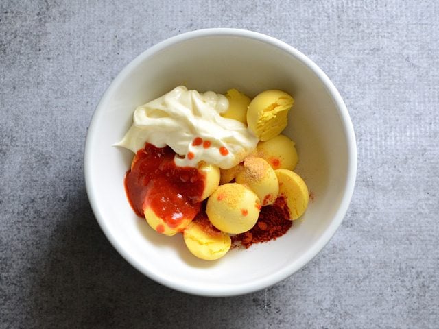 Egg yolks and spices in mixing bowl 