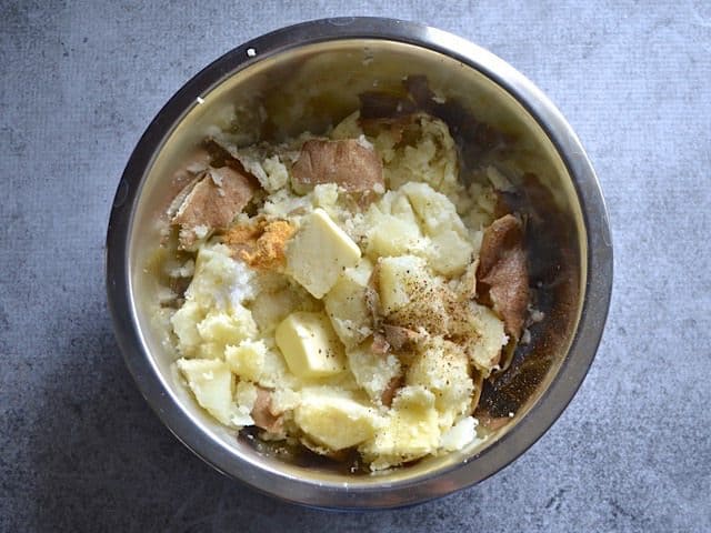 Potatoes chunks, Butter, Milk, and Seasoning in mixing bowl 