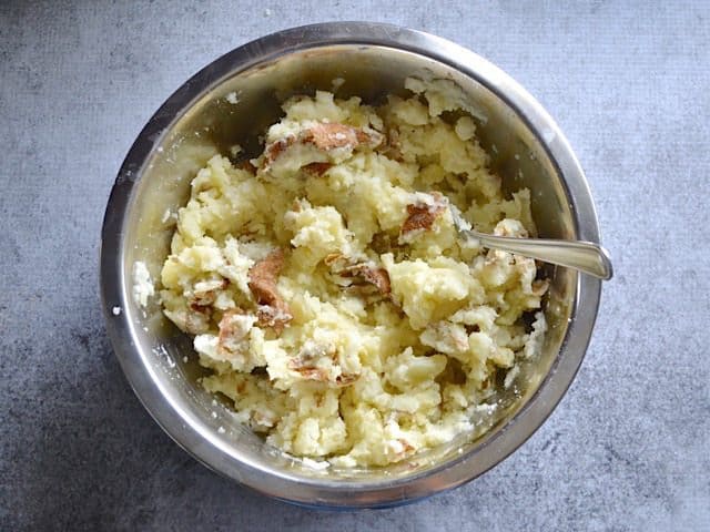 Chunky Mashed Potato mixture in bowl with fork 
