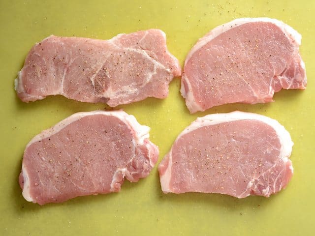 Four raw thin Cut Pork Chops