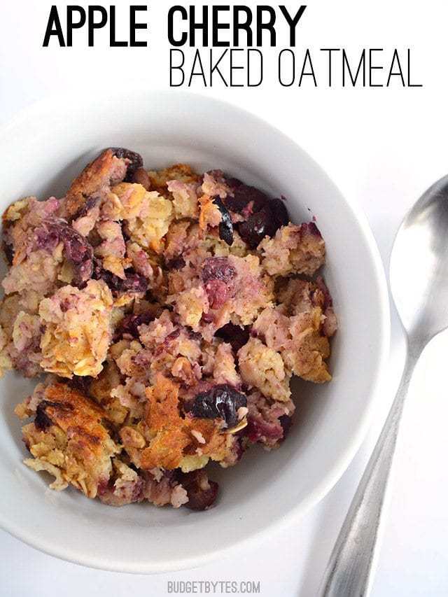 Top view of a bowl of Apple Cherry Baked Oatmeal with a spoon on the side 