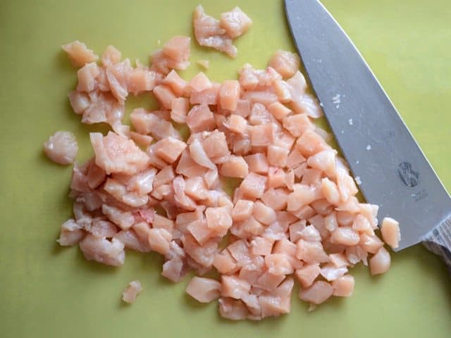 Chopped Chicken with knife on cutting board 