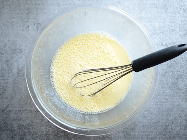 Crepe wet ingredients in mixing bowl with whisk 