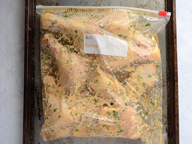 Raw chicken and marinade mixture in ziplock bag to marinate 
