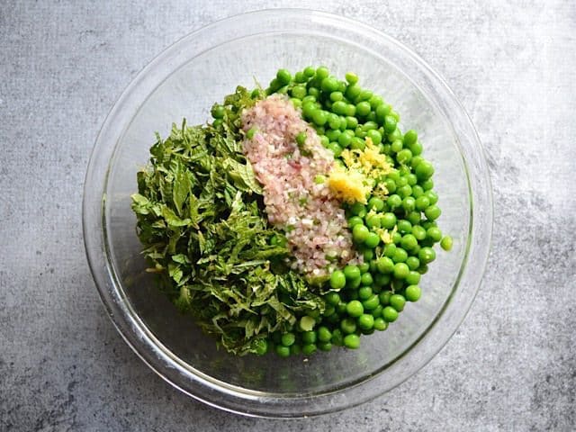 Peas, Dressing ,Mint and Zest in mixing bowl 