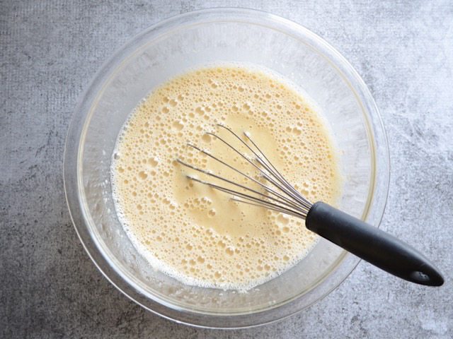 Milk added to wet ingredients in mixing bowl and whisked in