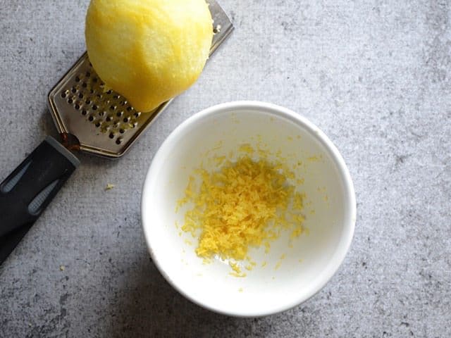 Zesting Lemon zest into small bowl 