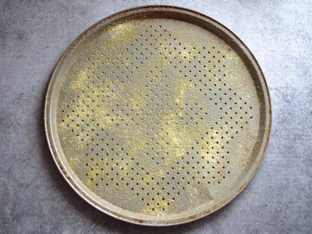 Prepared pizza Pan with cornmeal