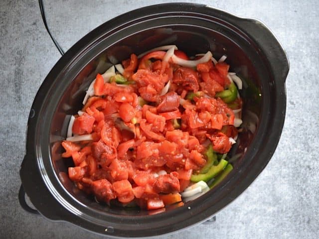 Tomatoes and Tomato Paste added to other ingredients in slow cooker 