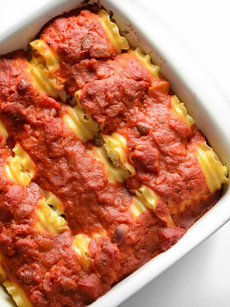 Overhead view of garden vegetable lasagna roll ups in a casserole dish