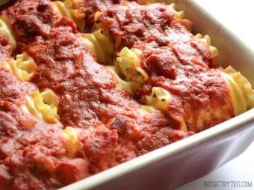 Side view of the casserole dish full of vegetable lasagna roll ups