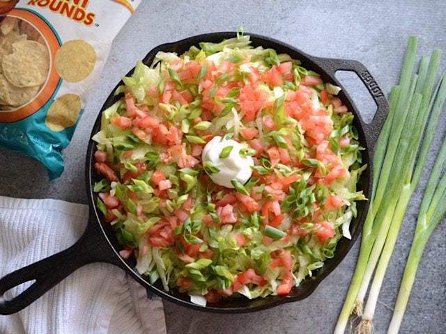 This entire taco salad is served right in the skillet used to cook the seasoned taco beef. Taco Salad Skillet is a fun, fast, and easy weeknight dinner. Budetbytes.com Lettuce, Tomato, Green Onion, and sour cream added to the skillet