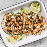 These light and refreshing Sweet Potato Tacos are filled with a simple sweet potato and black bean hash, and topped with a tangy lime crema. BudgetBytes.com