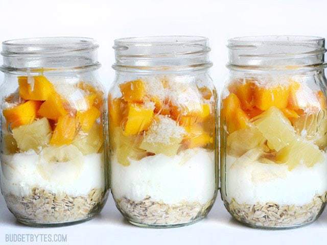 Tropical Yogurt Parfaits in jars, lined up side by side