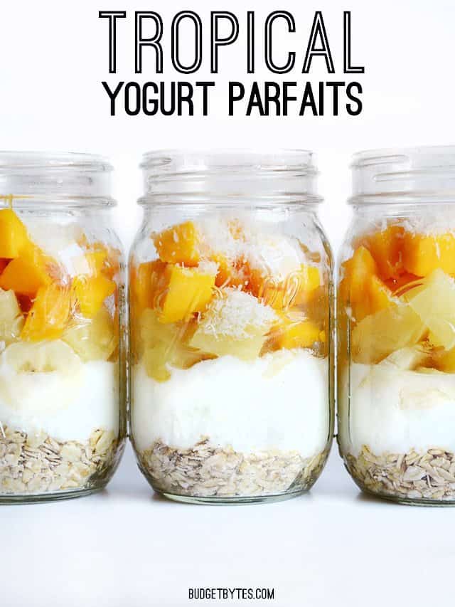 Side view of mason jars filled with Tropical Yogurt Overnight Oat Parfaits