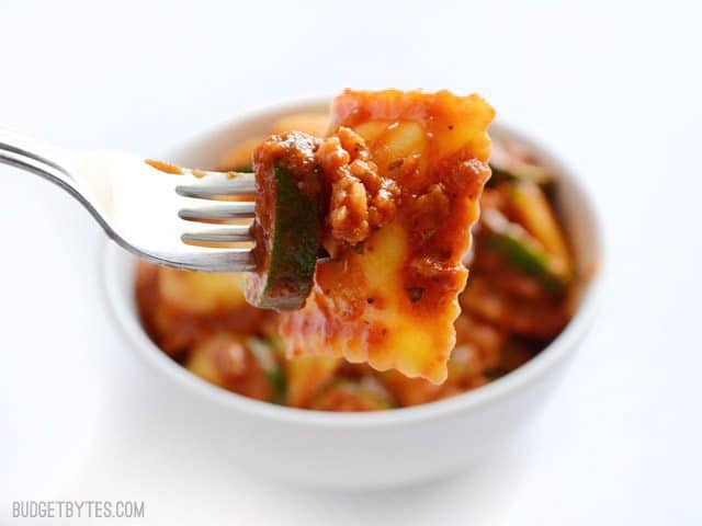 Adding a healthy dose of vegetables to these grocery store staples makes this Zucchini Sausage Ravioli a quick, delicious, and healthy weeknight dinner. Budetbytes.com Close up of a forkful of Zucchini Sausage Ravioli