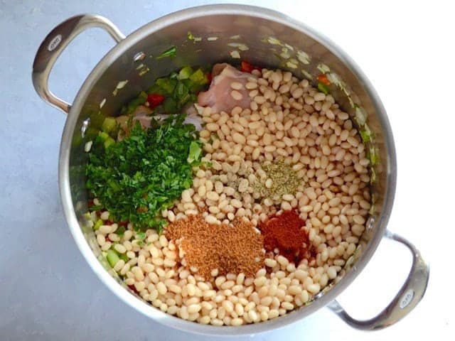 Soaked beans, spices, and parsley added to the pot