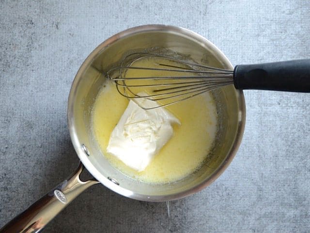 Milk, cream cheese, and salt added to sauce pot