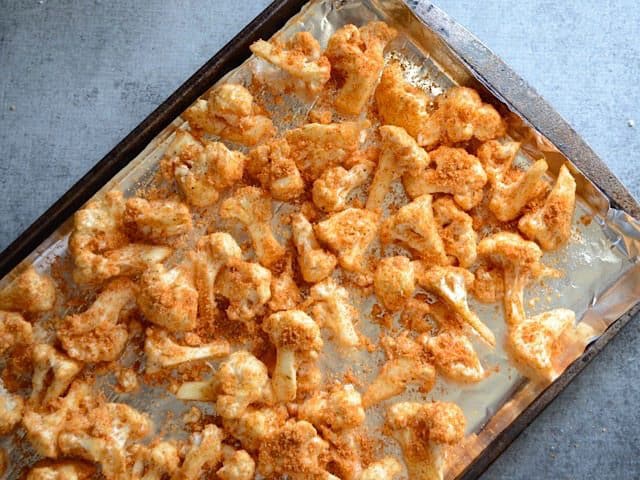 Cauliflower florets on a sheet pan, ready to roast