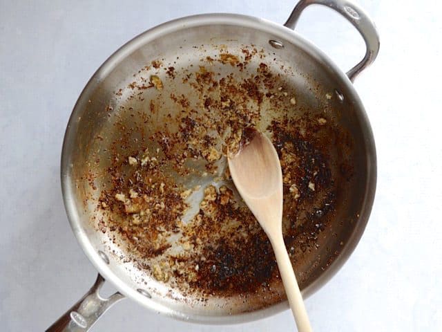 Minced garlic sautéed in the skillet with a wooden spoon