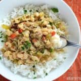 A bowl of creole white beans served with chicken.