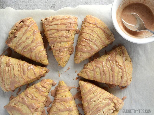 Glaze drizzled over baked apple pie scones