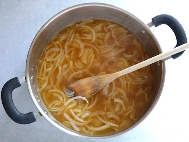 broth added to onions in the pot