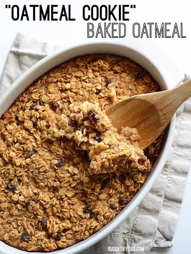 A casserole dish full of oatmeal cookie baked oatmeal with a wooden spoon scooping some from the side