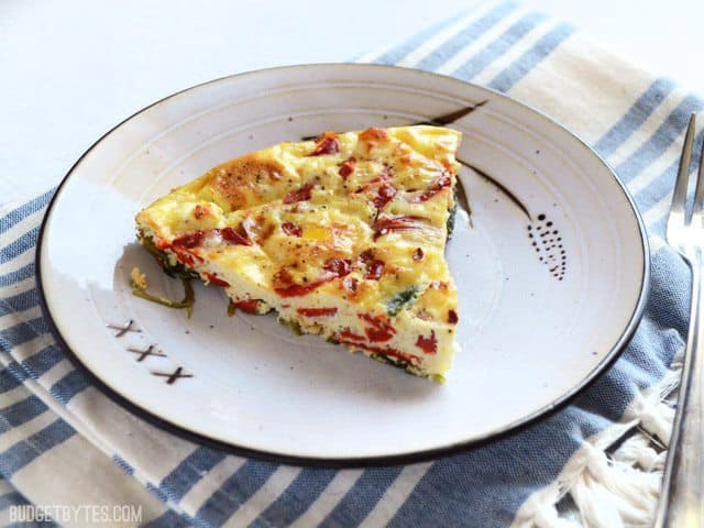 One slice of Roasted Red Pepper and Feta Frittata on a plate