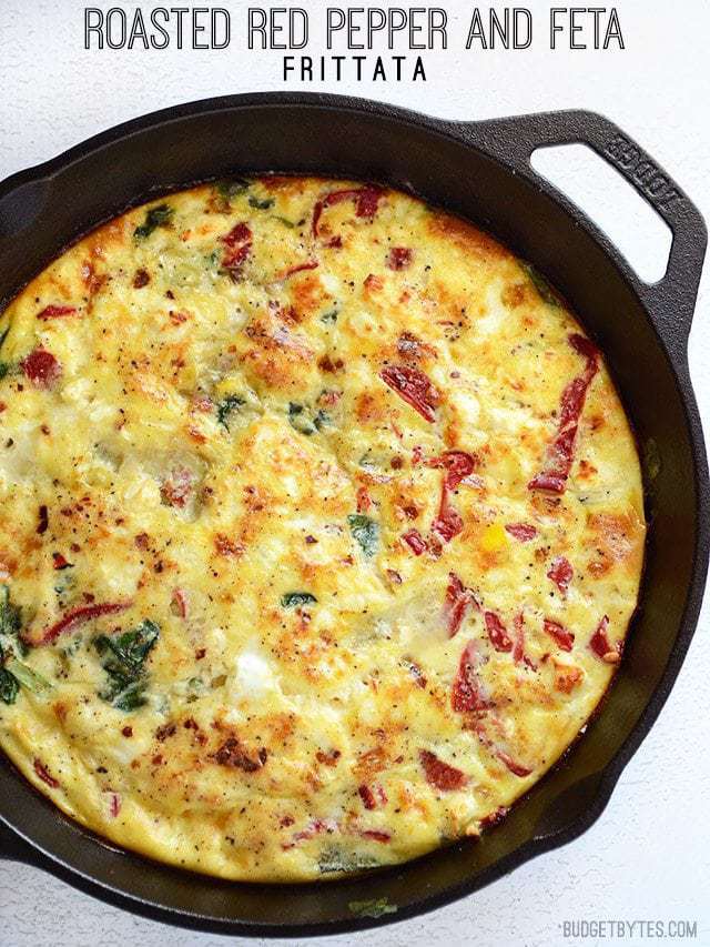 Overhead view of Roasted Red Pepper and Feta Frittata in a cast iron skillet, title text at the top.