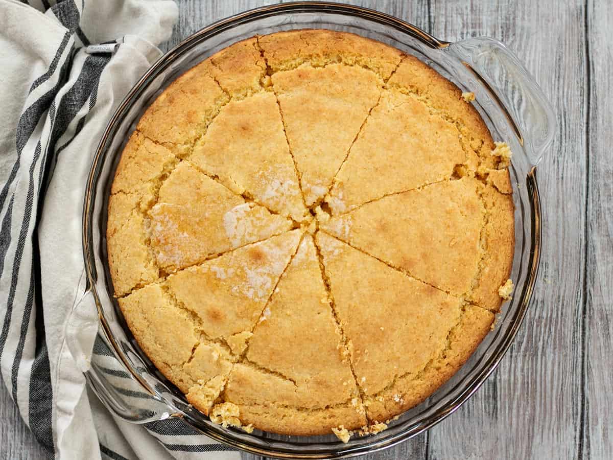 Overhead view of cornbread sliced into pieces in the baking dish.