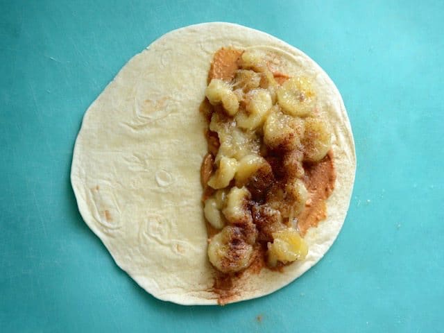 Caramelized banana added on top of the peanut butter in the tortilla, topped with cinnamon