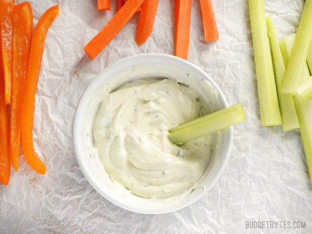 Overhead view of a celery stick dipped into Dilly Vegetable Dip 