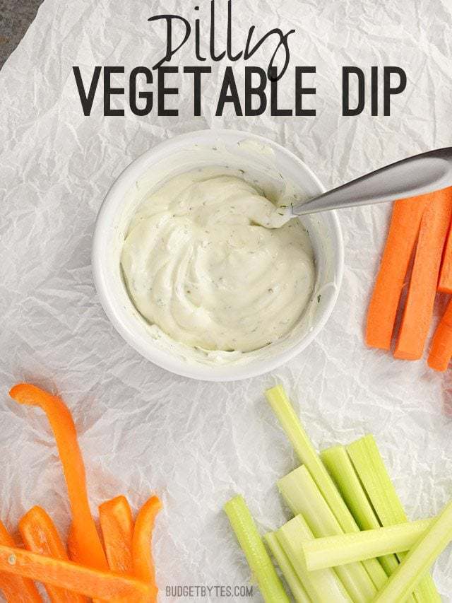 A small bowl of Dilly Vegetable Dip surrounded by vegetable sticks