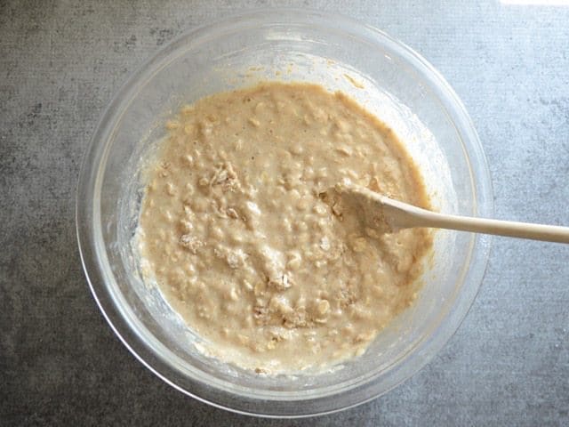 Lightly Mixed Muffin Batter in a glass bowl with a wooden spoon