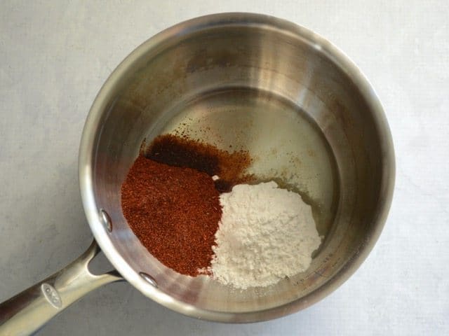 Oil Flour and Chili Powder in a sauce pot