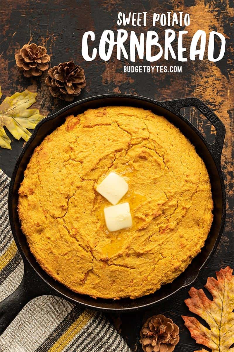 sweet potato cornbread in a cast iron skillet with butter on top