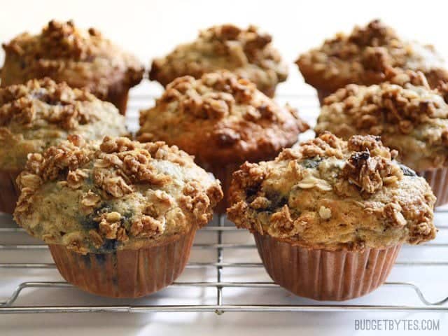 Several Triple Berry Oatmeal Muffins on a wire cooling rack