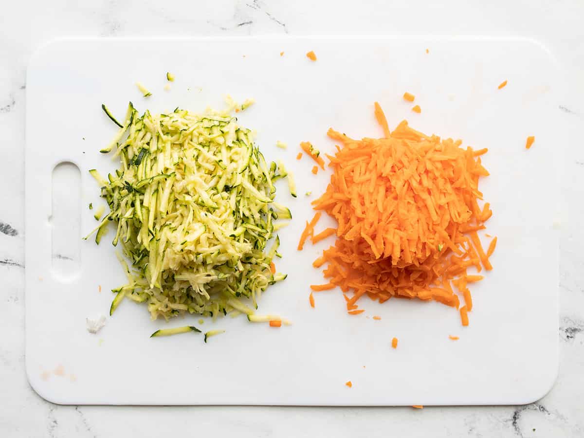 Shredded zucchini and carrot on a cutting board