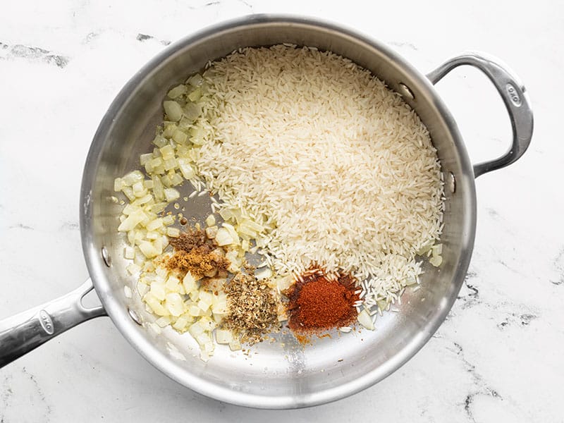 Rice and spices added to the skillet