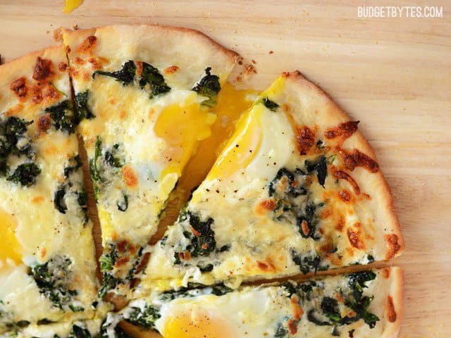 Close up side view of slices of Eggs Florentine Breakfast Pizza 