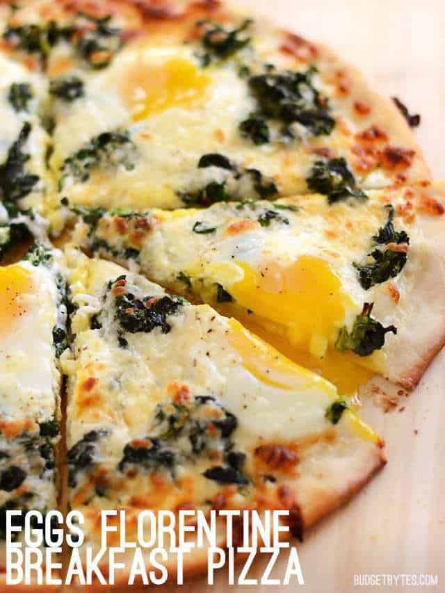 Close up side view of an egg topped pizza, sliced through a runny yolk