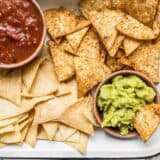 These Homemade Baked Tortilla Chips are fast, easy, super crunchy, a great way to use up leftover tortillas, and a great alternative to store bought chips. Budgetbytes.com