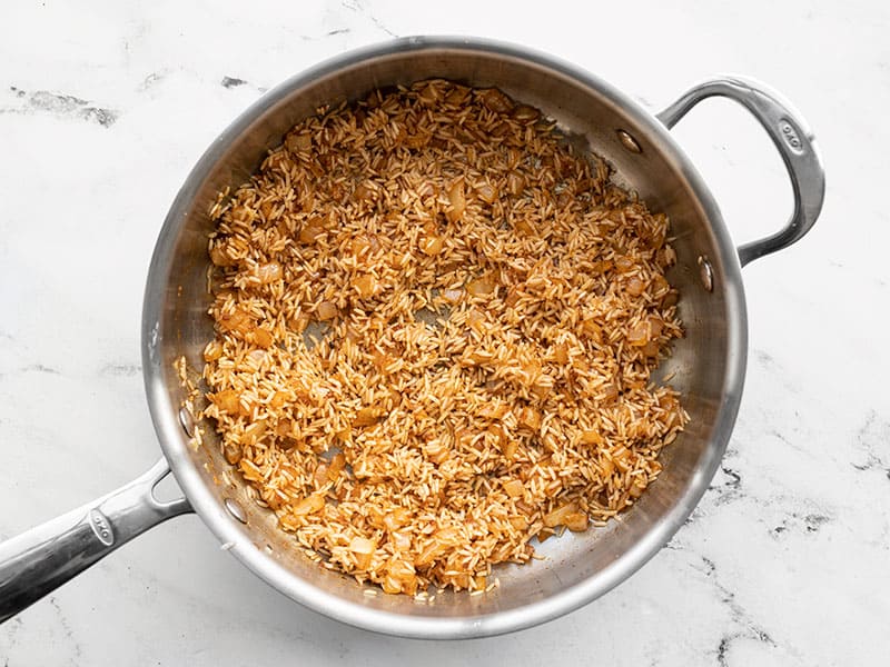 Cooked rice and spices in skillet