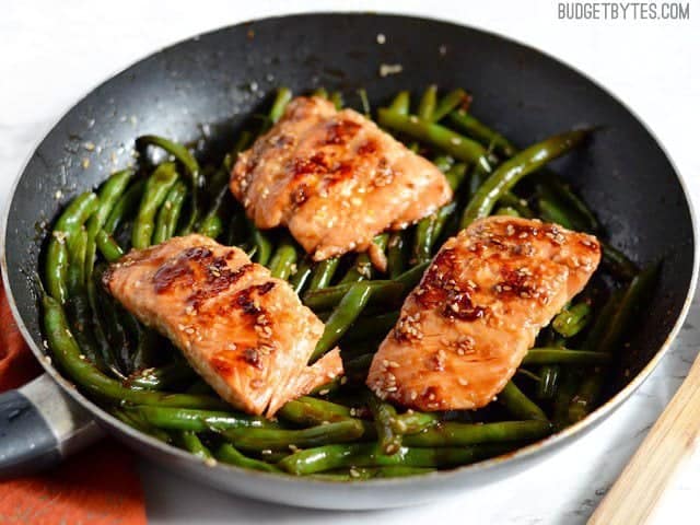 Side view of a pan with Sesame Glazed Salmon and Green Beans inside