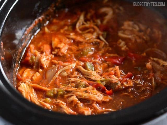 Close up side view of a Slow Cooker filled with Italian Chicken and Peppers 